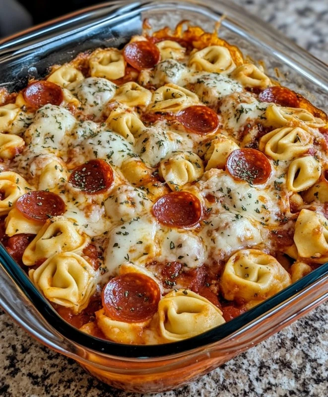 Cheese Tortellini Pepperoni Pizza Casserole topped with melted cheese and pepperoni
