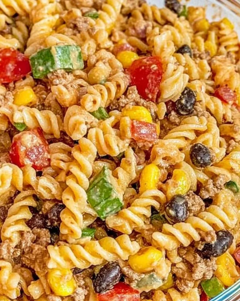 Colorful Cowboy Pasta Salad with vegetables and dressing in a bowl.