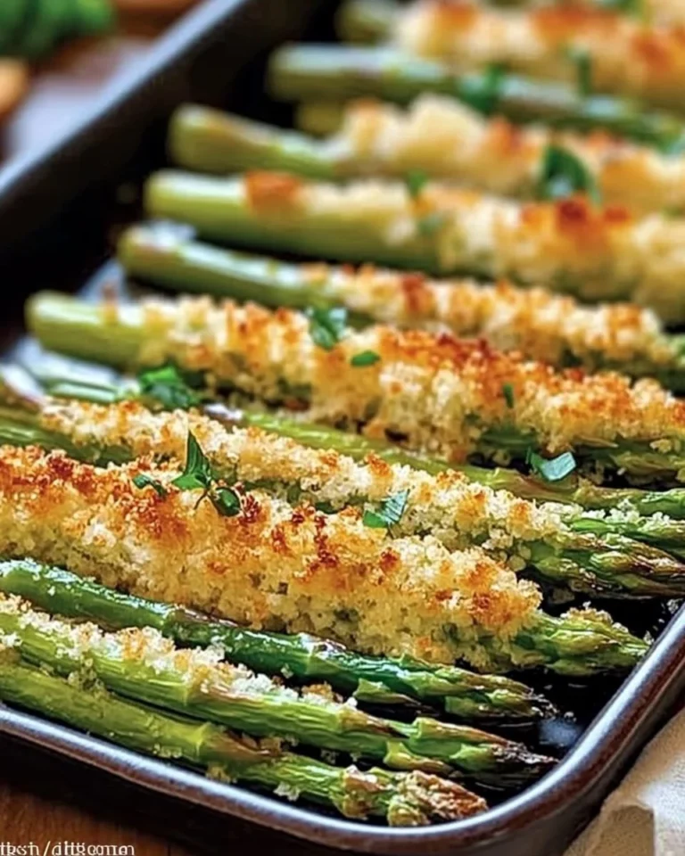 Plate of crispy baked asparagus garnished with herbs