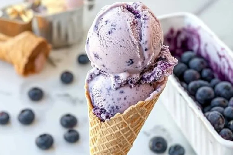 Bowl of easy homemade no churn blueberry ice cream topped with fresh berries