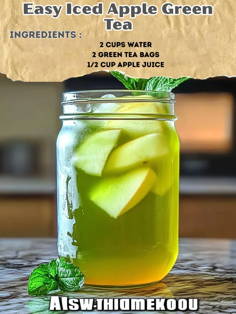 A refreshing glass of iced apple green tea with apple slices and mint leaves.
