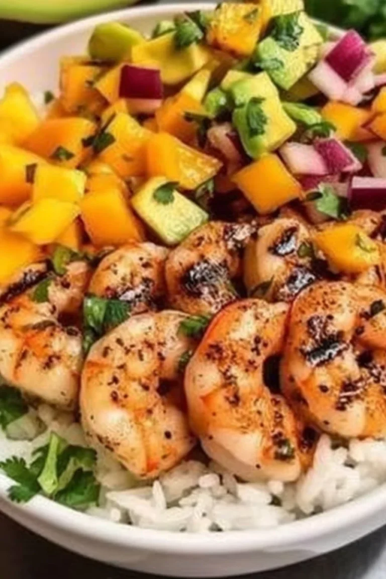 Spicy shrimp and avocado rice bowls topped with mango salsa and lime-chili drizzle