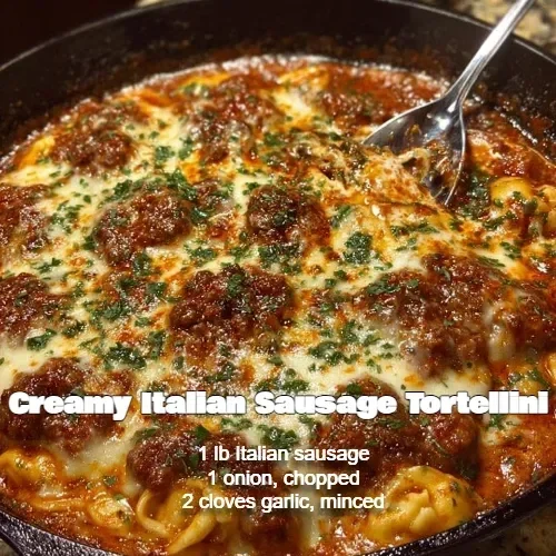 Bowl of creamy Italian sausage tortellini garnished with parsley