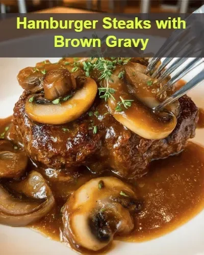 Delicious hamburger steaks topped with savory brown gravy, served on a plate.