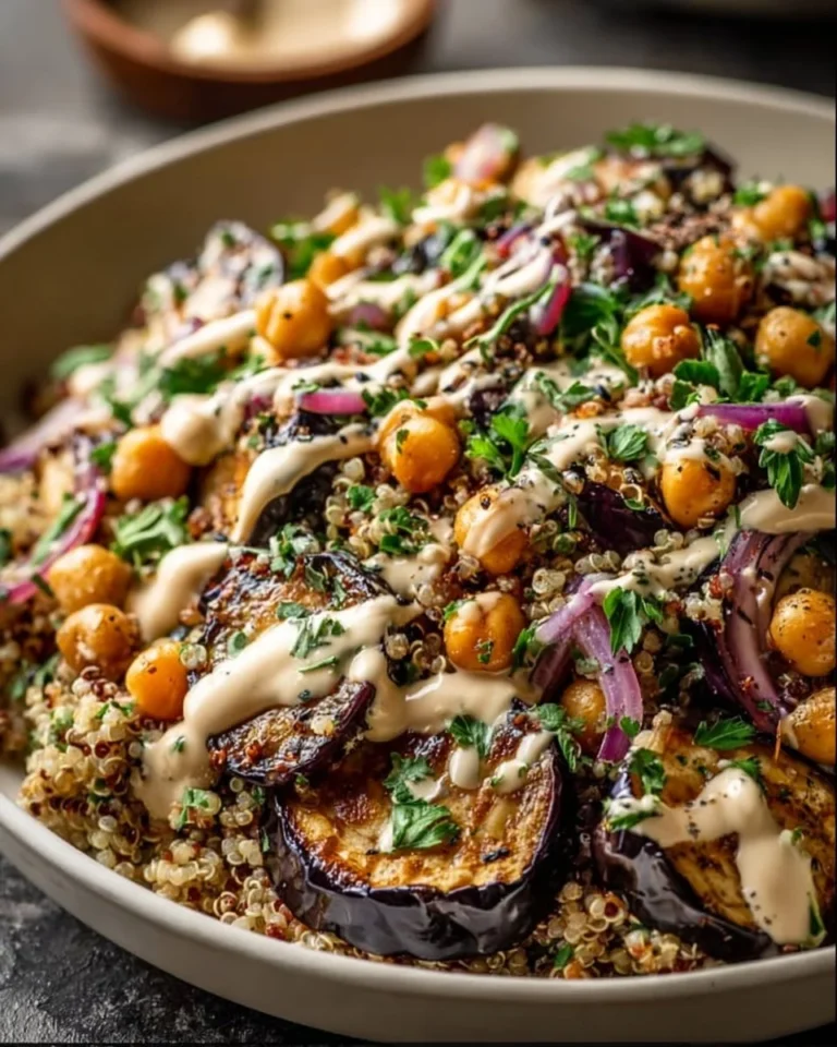 Roasted eggplant, chickpea, and quinoa salad drizzled with tahini dressing